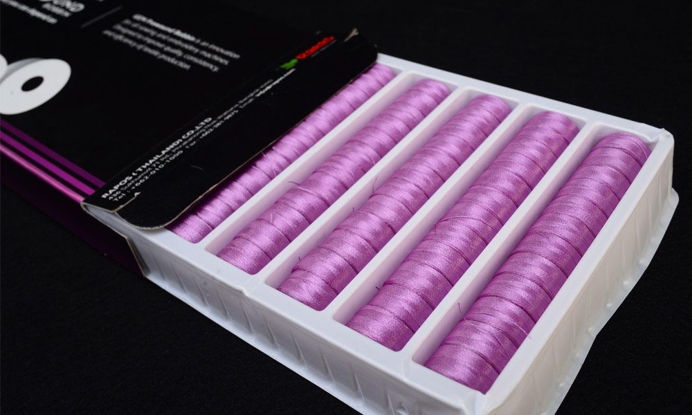 packet of purple gem coreless prewound bobbin